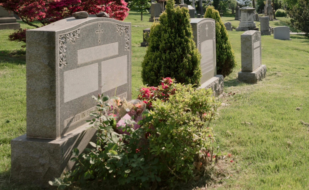 Row of upright memorial monuments in a cemetery